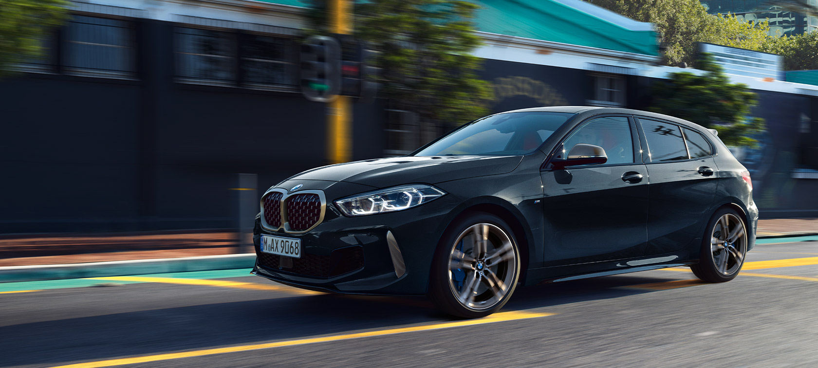 BMW M135i xDrive (F40) in Black Sapphire metallic Driving car in urban environment