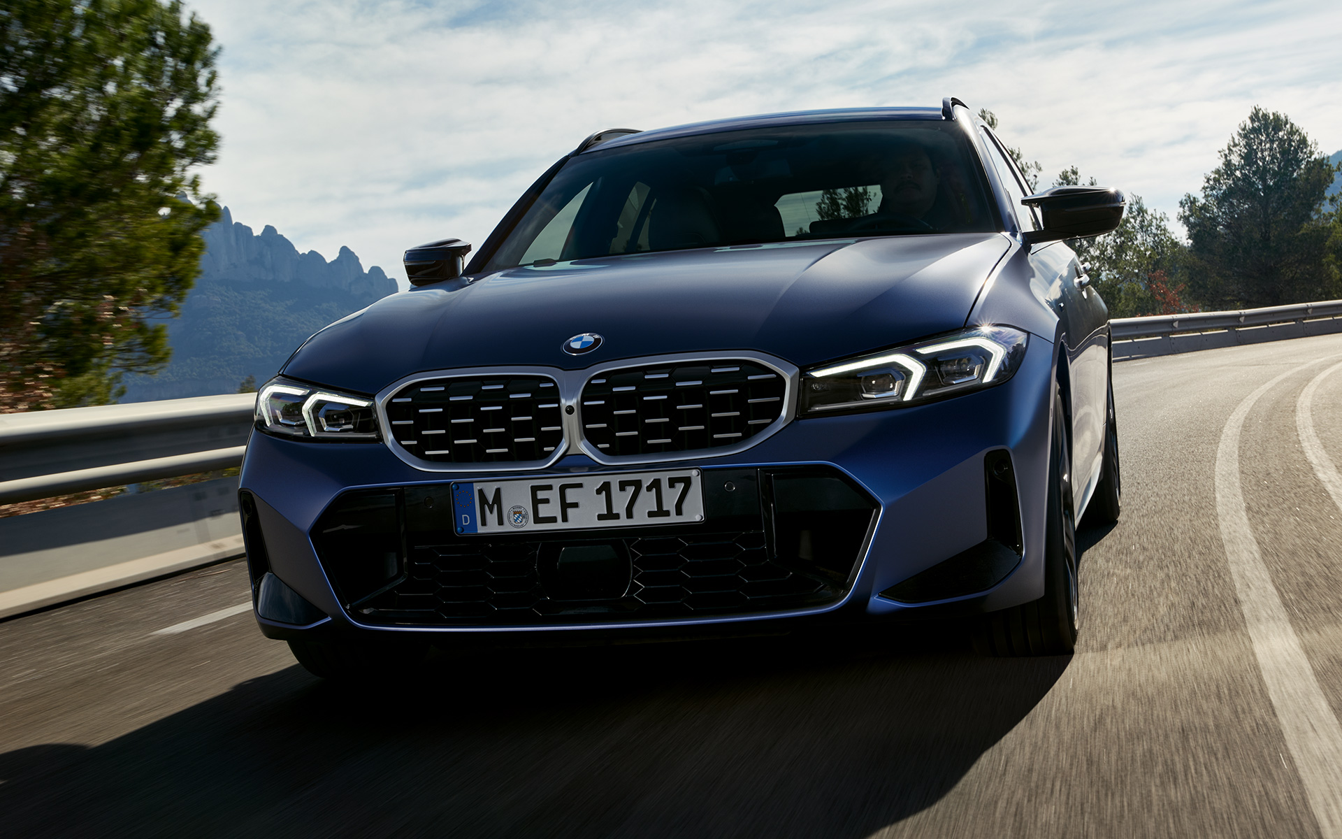 BMW M340i xDrive Touring G21 Frozen Tanzanite Blue front view driving on the street