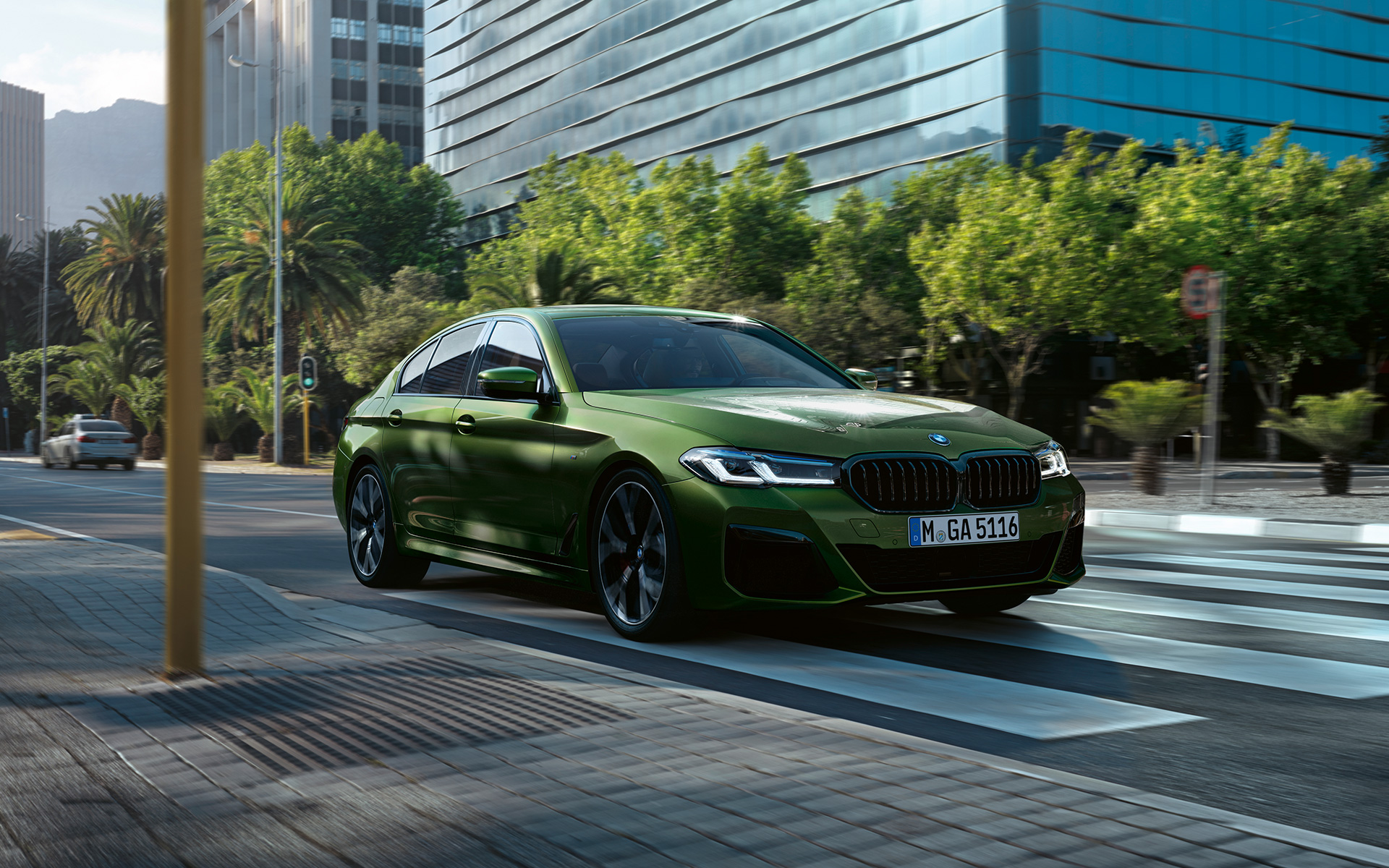 BMW M550i xDrive Sedan G30 LCI Facelift 2020 BMW Individual Verde Ermes metallic three-quarter front view driving